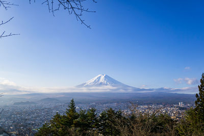 Scenic view of snowcapped mountain against blue sky