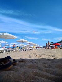 Group of people on beach against sky