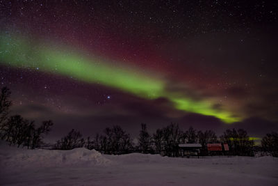 Scenic view of snowcapped mountains against sky at night