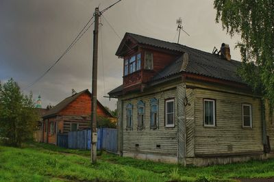 An old house on field against sky