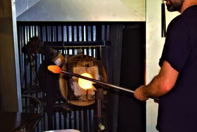 Midsection of man working in kitchen