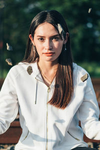 Portrait of young woman sitting outdoors