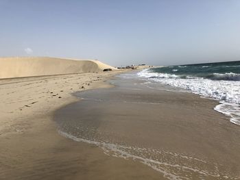 Scenic view of beach against clear sky