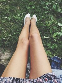 Low section of woman sitting outdoors