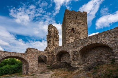 Low angle view of historic building against cloudy sky