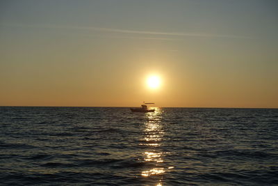 Scenic view of sea against clear sky during sunset