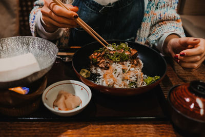 Midsection of man having food on table