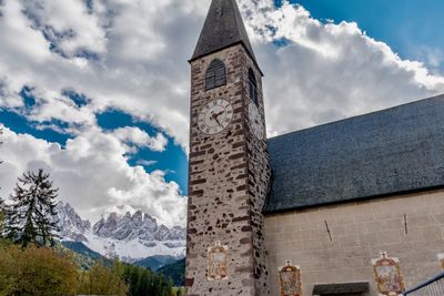 Low angle view of tower against cloudy sky