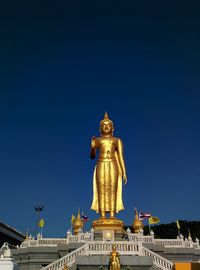 Statue of temple against clear blue sky