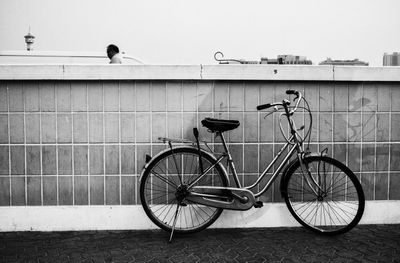 Bicycle parked against wall