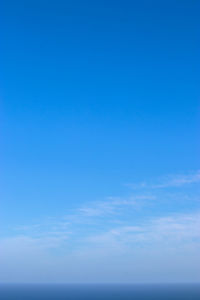 Low angle view of sea against blue sky
