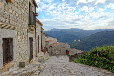 Scenic view of buildings and mountains against sky