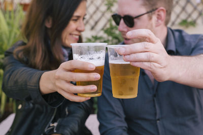 Midsection of a man holding drink