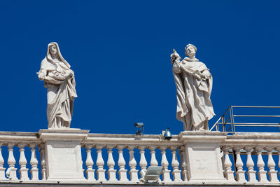 Low angle view of statue against blue sky