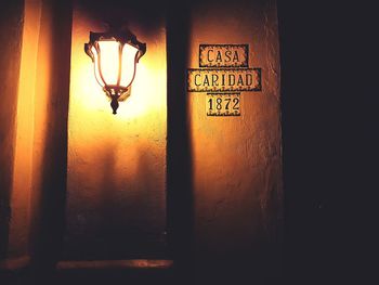 Close-up of illuminated text on wall