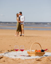 A couple of a man and a woman walk on the beach on a date.  lovers spend time together