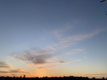 Low angle view of silhouette trees against sky during sunset