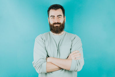 Portrait of young man against blue background