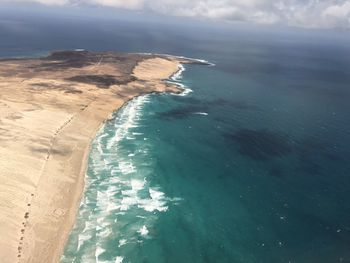 Aerial view of beach and sea against sky