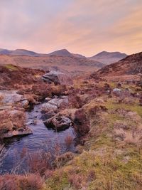 Scenic view of land against sky during sunset