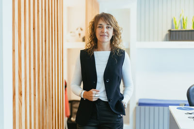 Portrait of young businesswoman standing in office