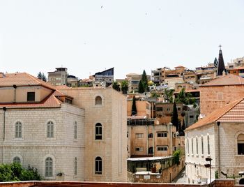 Buildings in city against clear sky