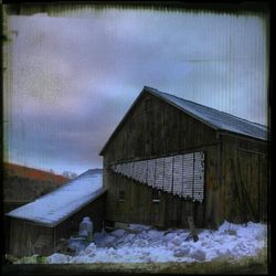 Houses against cloudy sky