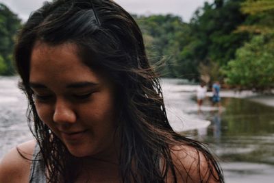 Close-up of young woman at lakeshore