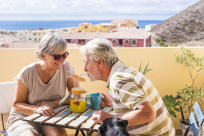 Senior couple enjoying wine at outdoors restaurant