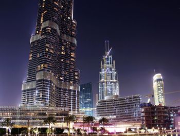 Illuminated burj khalifa against sky at night