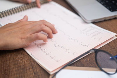 Cropped image of man working on table