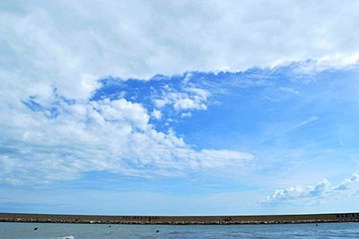 Scenic view of sea against cloudy sky