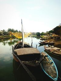 Boats moored in lake against sky