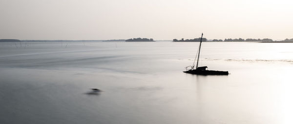 Sailboat in sea against sky