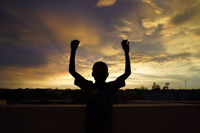 Silhouette man standing against sky during sunset