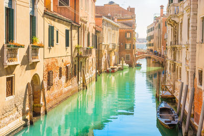Bridge over canal amidst buildings in city