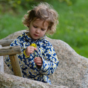 Cute girl holding yellow flower