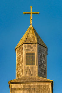 Low angle view of chapel against clear blue sky