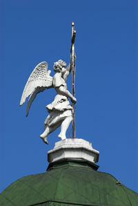 Low angle view of statue against clear blue sky
