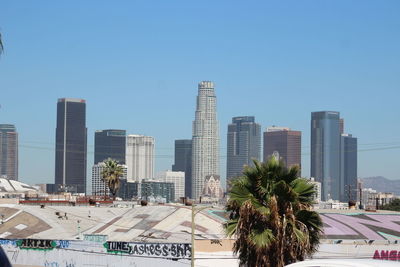 Modern buildings in city against clear sky