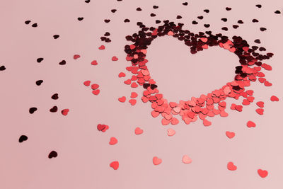 Close-up of heart shape against red background