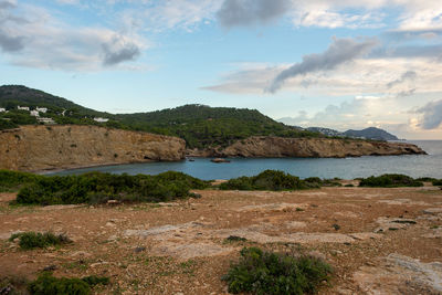 Scenic view of sea and mountains against sky