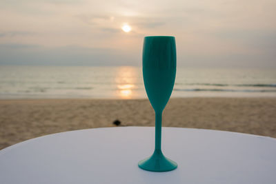 Close-up of water on beach against sky during sunset