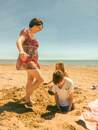 Woman on beach against sky