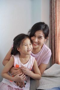 Mother and girl smiling