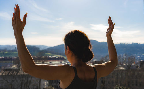 Woman raising her arms