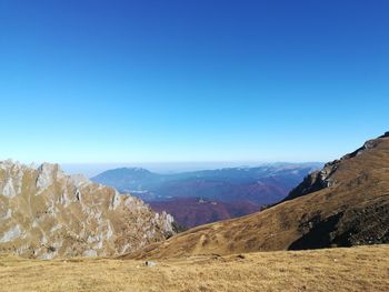 Panoramic view of landscape and mountains against clear blue sky