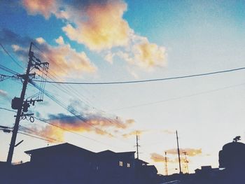 Low angle view of electricity pylon against sky