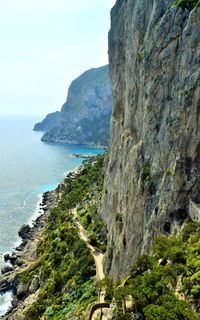 Scenic view of sea and mountains against sky