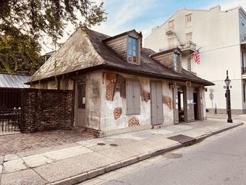 Houses by street against sky in city